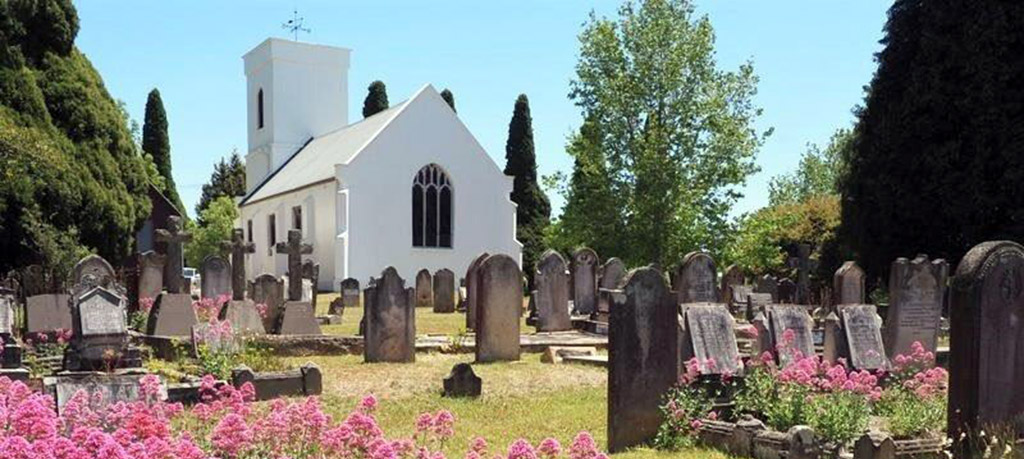 Western view of Christ Church Bong Bong with early cemetery grave stones in the foreground